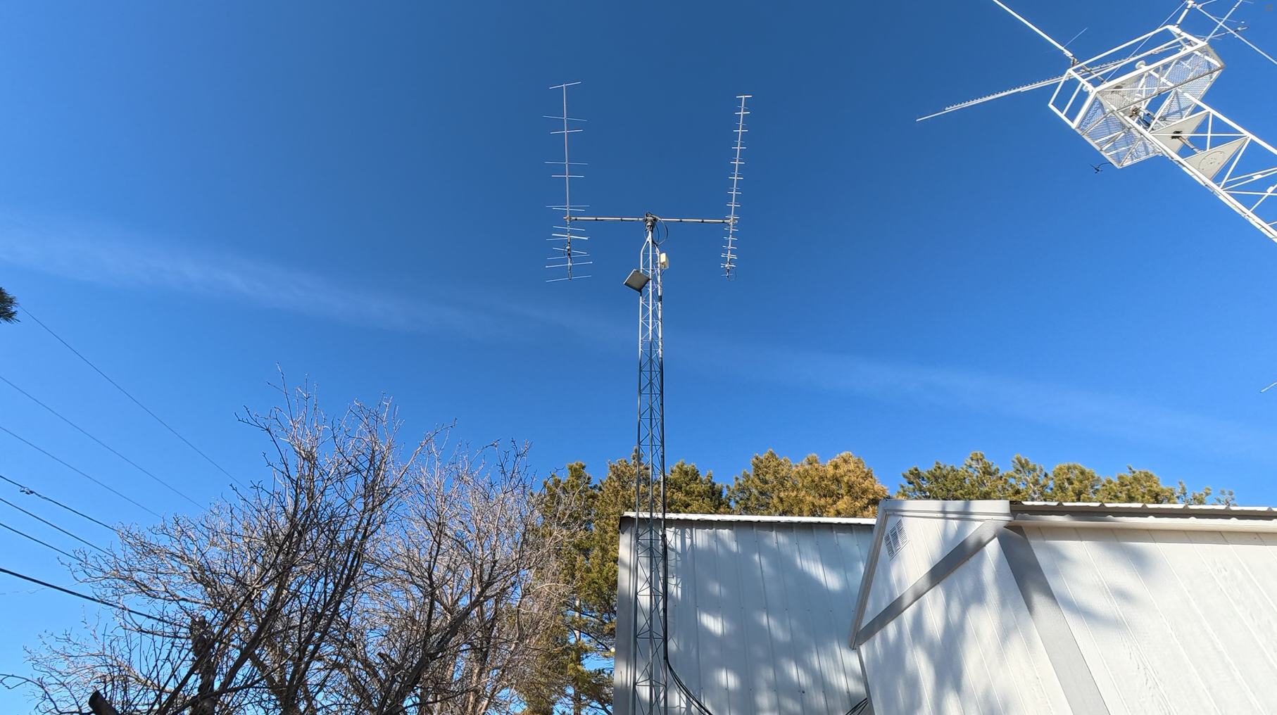 Directional amateur radio antennas against a blue sky