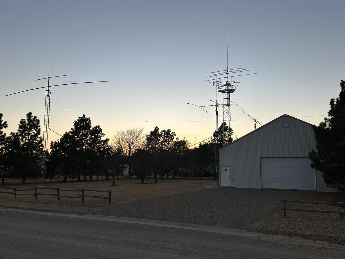 Amateur radio towers and antennas at sunset